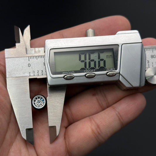 Miniature wheel with blue hub, measured with digital caliper