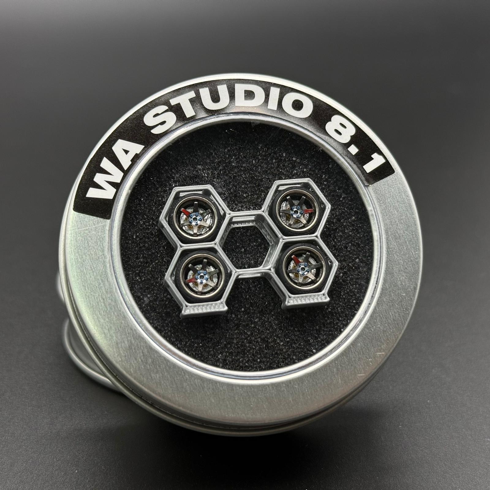Silver wheel cap with black center and six gem-like lug details