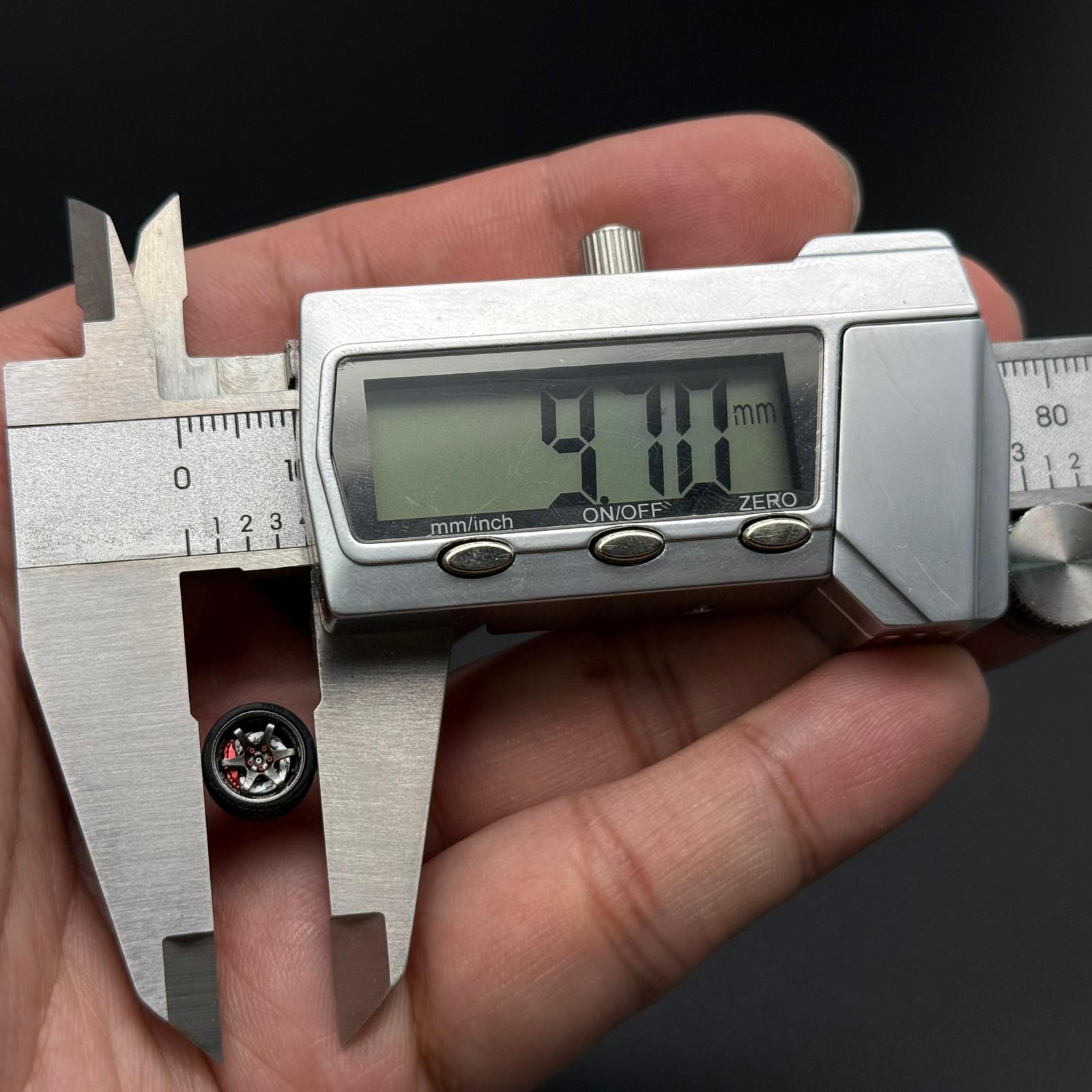 1/64 TE37 wheel size measurement with caliper; silver rim and hex star center