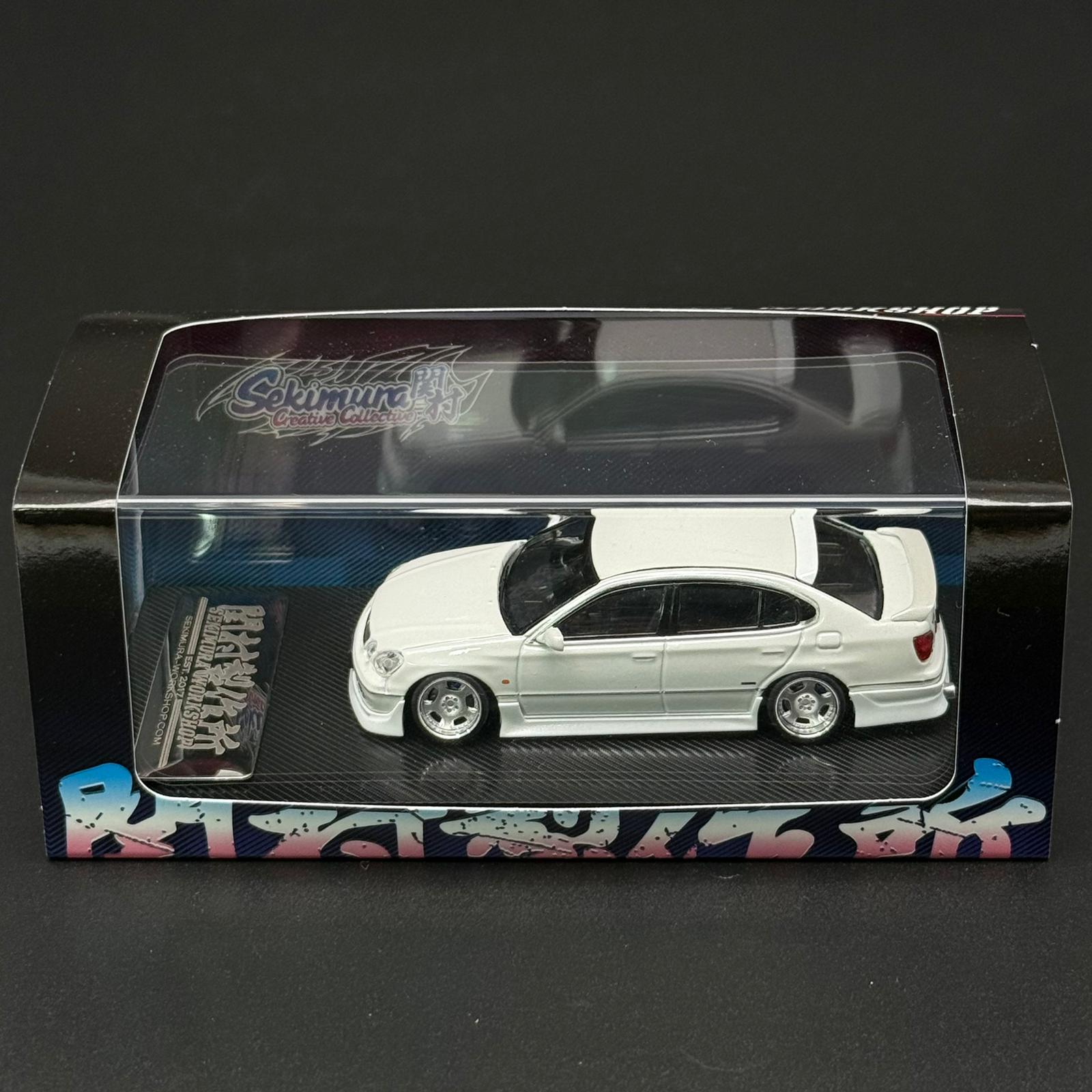 1/64 white model car in retail box with clear window and black base