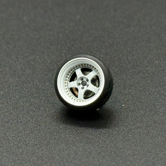 Single 1/64 S1 wheel with silver multi-spoke metal rim and dark tire