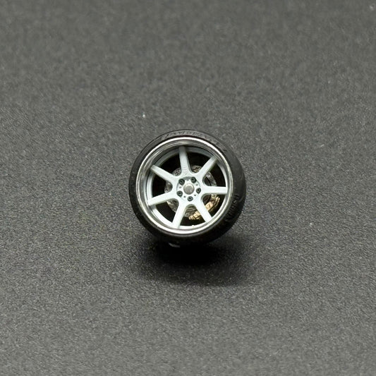 Miniature wheel with silver multi-spoke rim and black tire