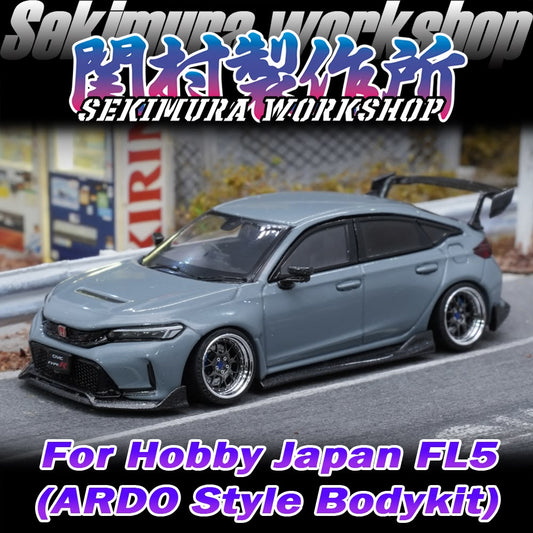 Light blue model car front three-quarter view with body kit and rear wing