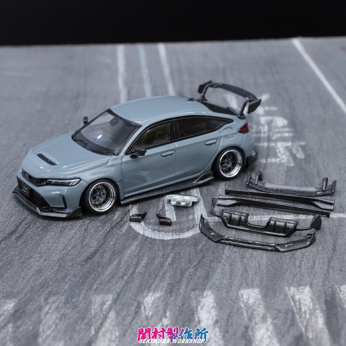 Light blue model car with body kit: front splitter, side skirts, rear diffuser