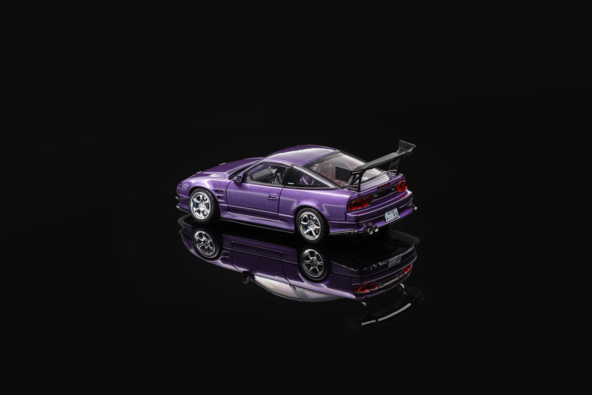 Purple 1/64 scale sports car model, rear-left view with exhaust and spoiler