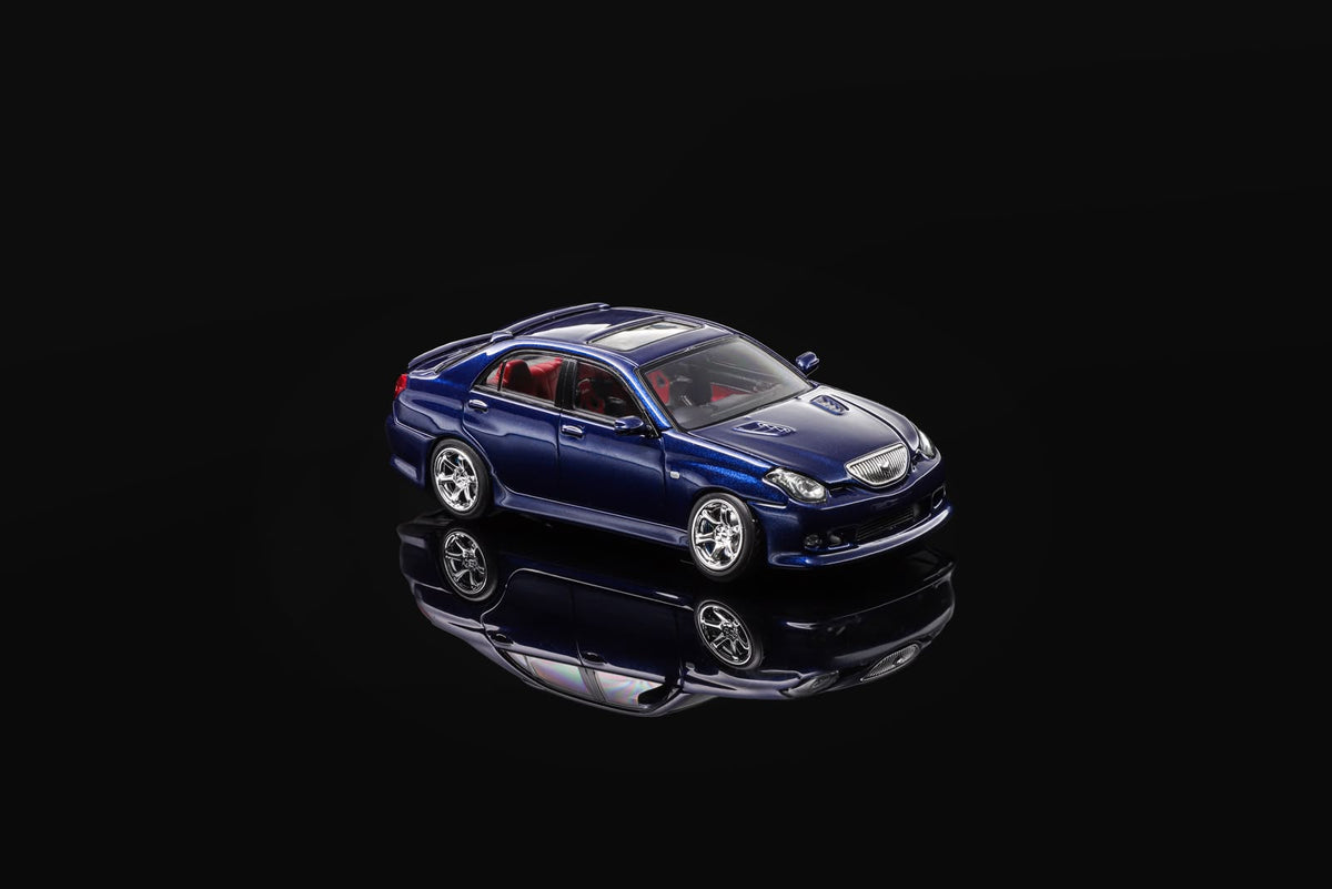 Blue 1/64 scale model sedan, front three-quarter view with headlights.