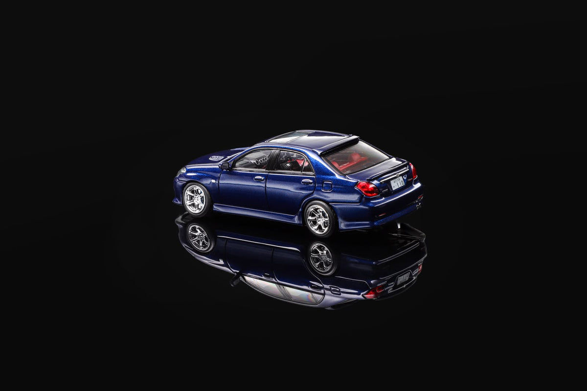 Blue 1/64 scale model sedan, rear three-quarter view with tail lights.