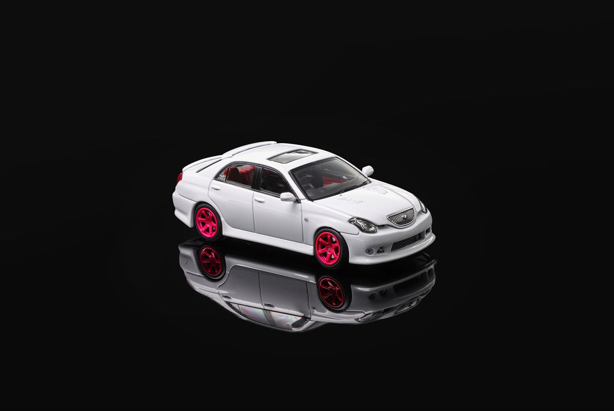 White 1/64 die-cast sports car model with pink wheels, angled front view