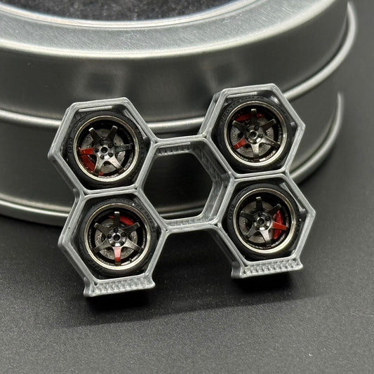 Close-up of four gunmetal TE37SL model wheels in a linked display holder