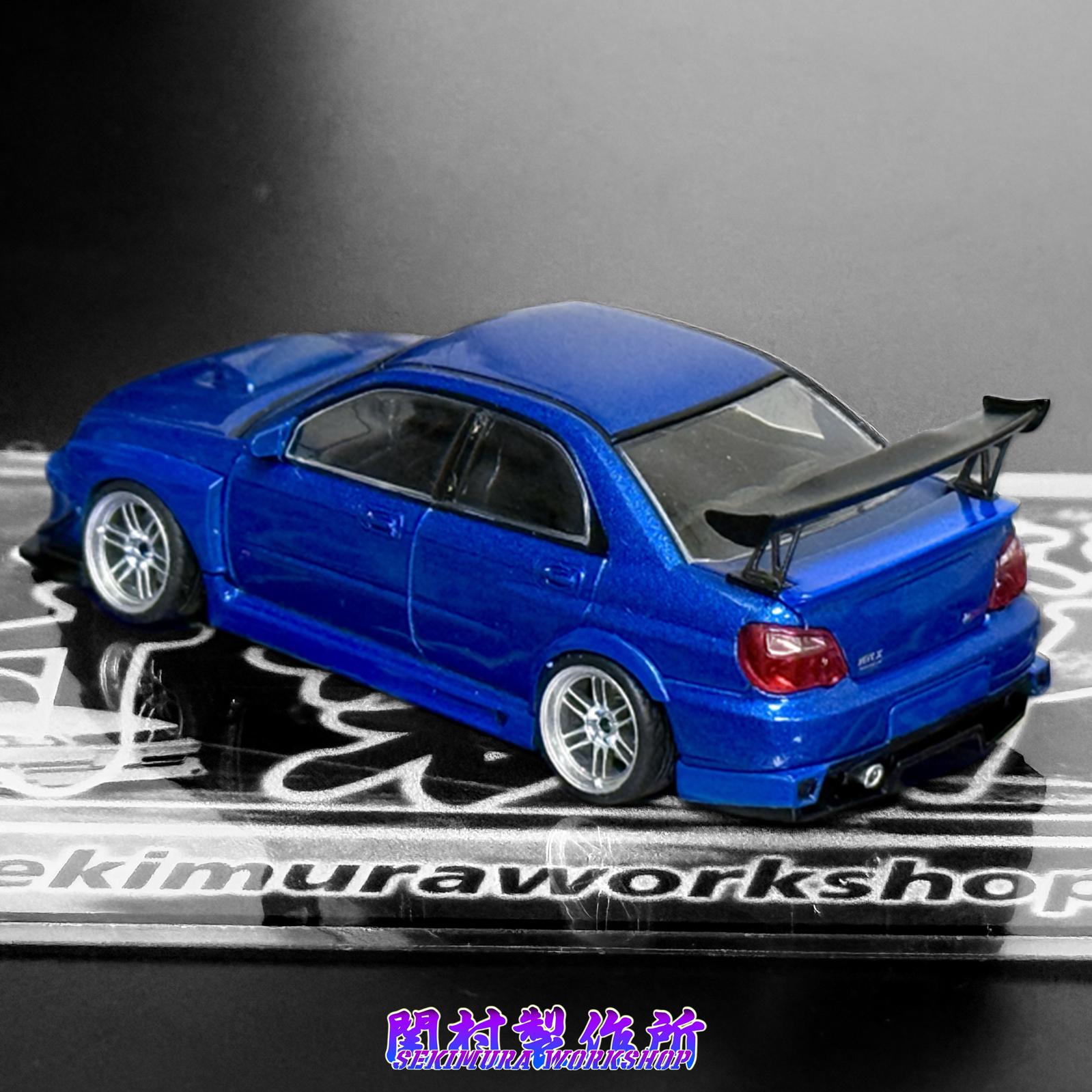 Blue SUBARU WRX STI model car with M-sports bodykit, rear three-quarter view