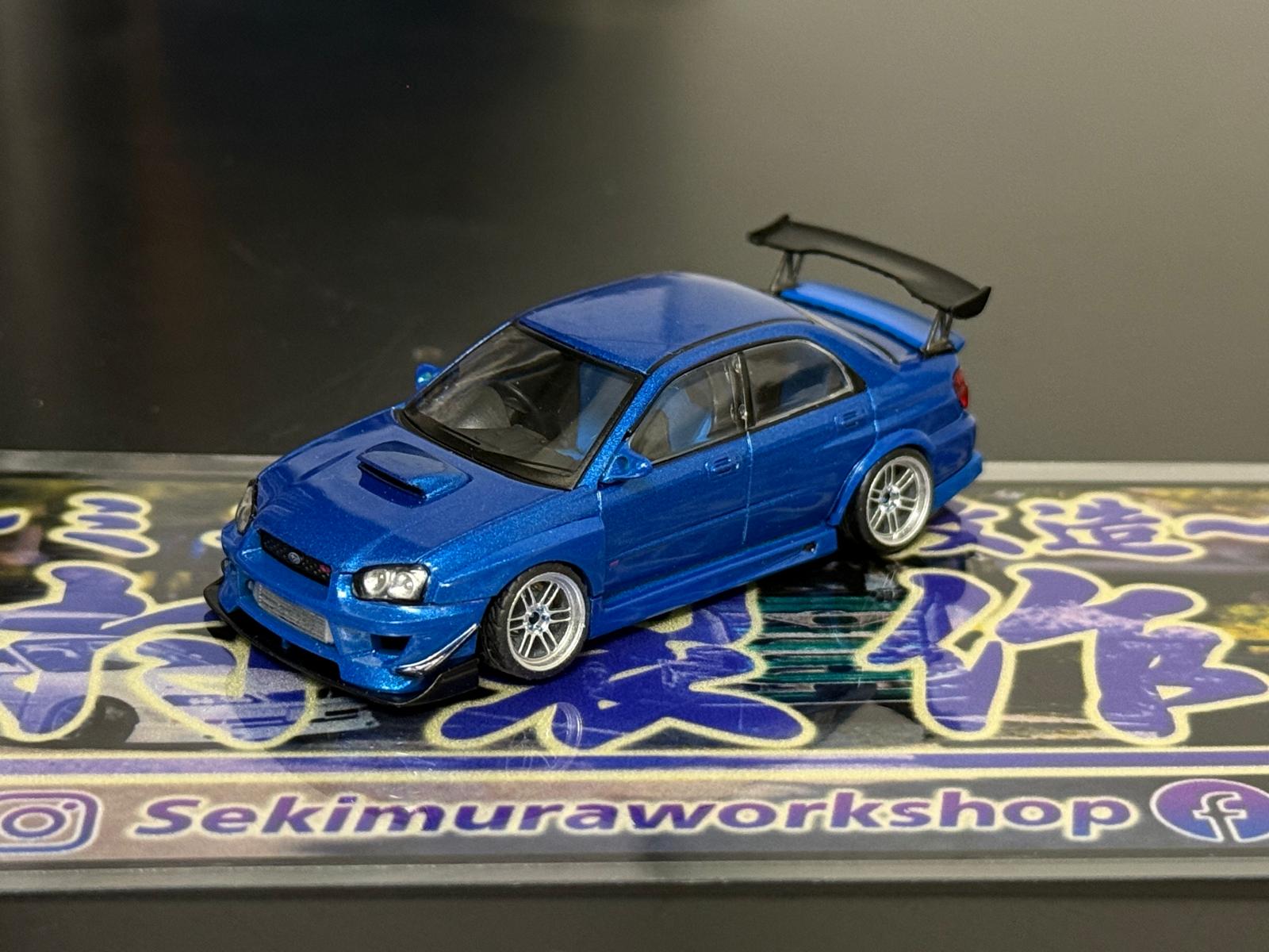 Blue SUBARU WRX STI model car with M-sports bodykit, angled side view