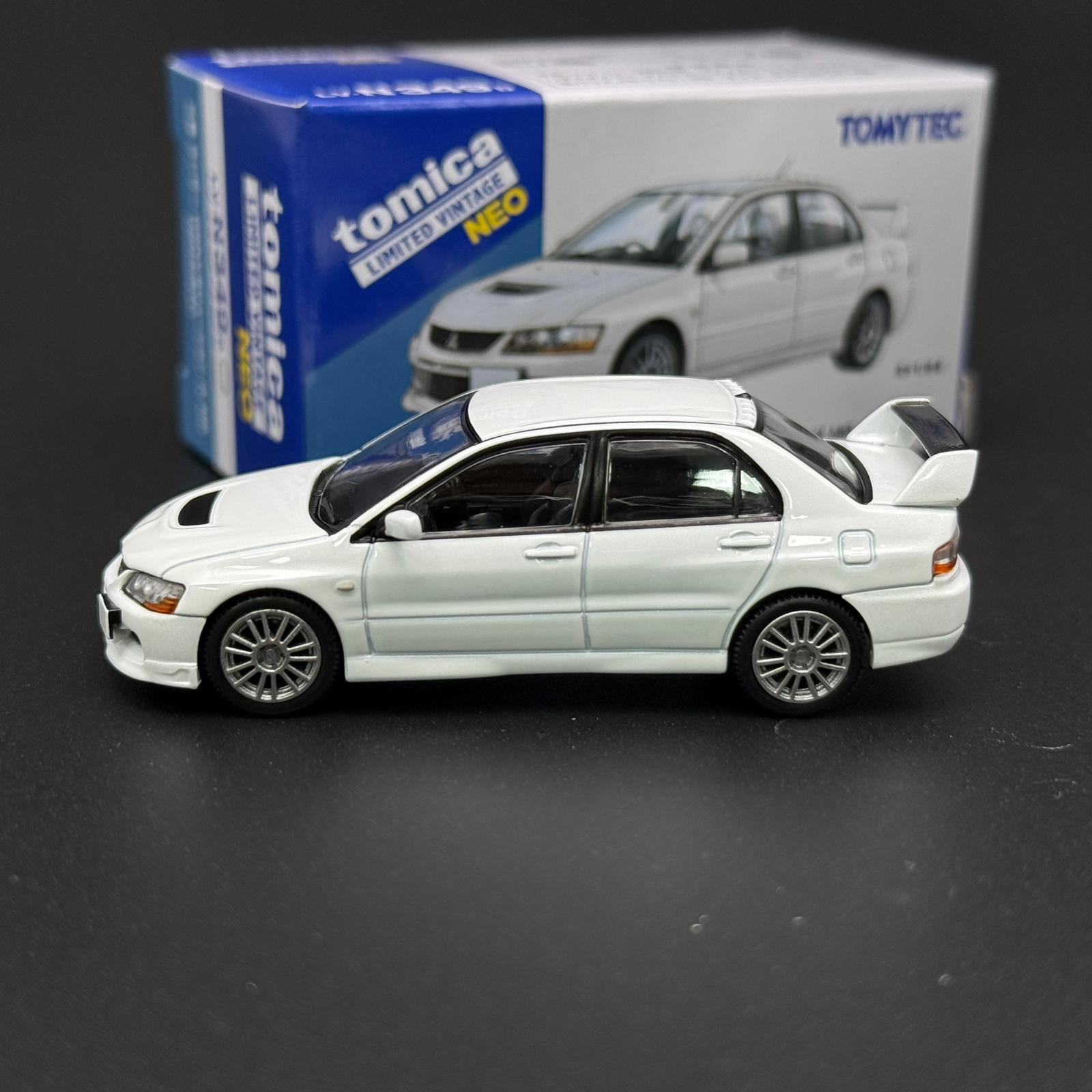 White die-cast car model in side view with alloy-style wheels