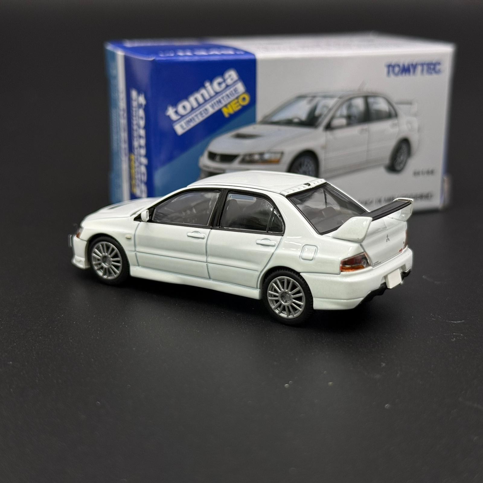White die-cast car model with rear-left 3/4 view and raised hood