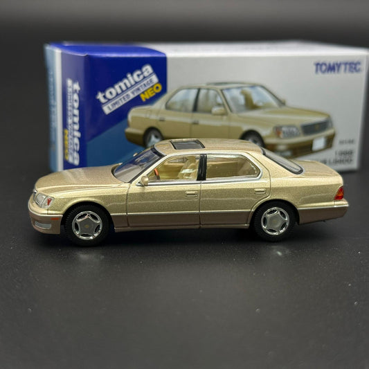 Gold two-door die-cast car model in side profile with silver wheels