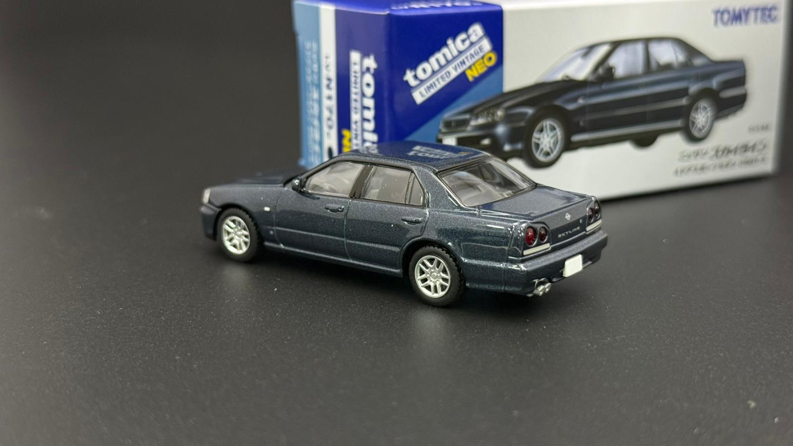 Tomytec 1/64 ER34 4-Door dark grey-blue model car, front view