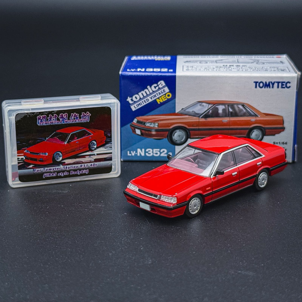 Retail box set with red scale model sedan and display case