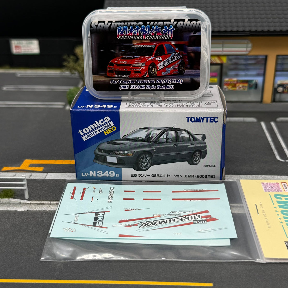 Tomytec EVO9 body kit set with boxed model and sheet of red, black, and white decals.