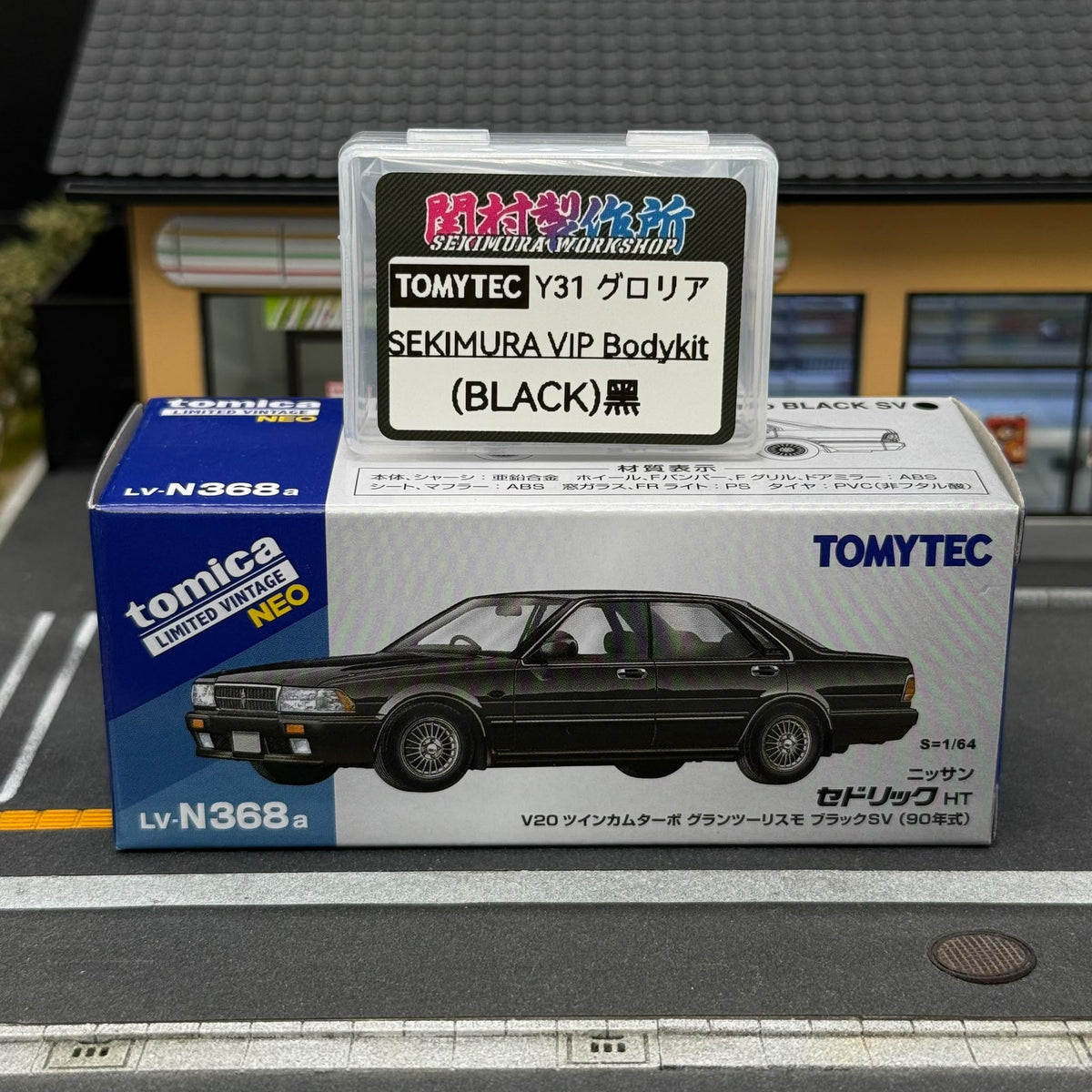 Black Sekimura VIP bodykit package for Tomytec Nissan Y31 Cedric, shown with model box