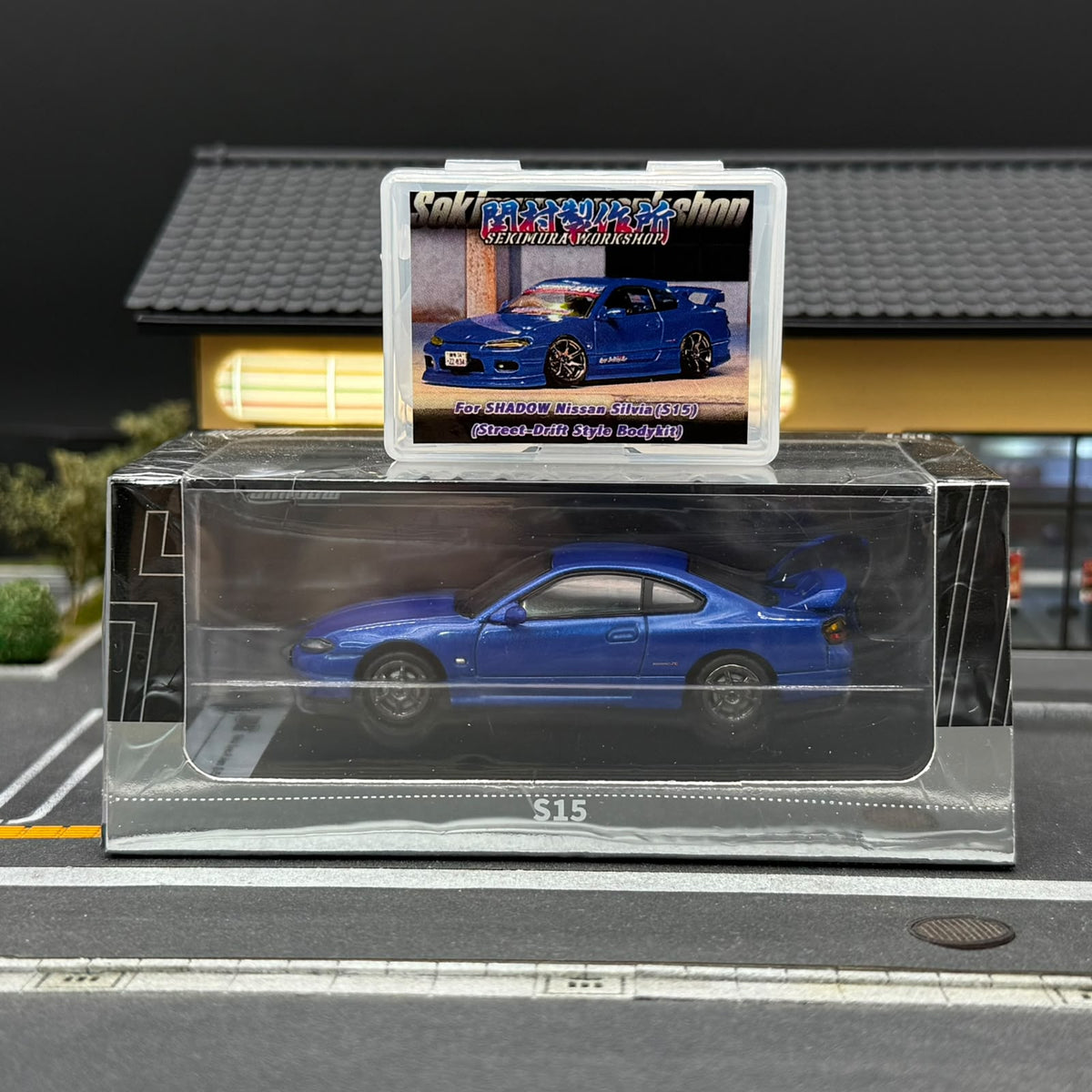 Blue S15 scale model car with bodykit, rear wing, and display box